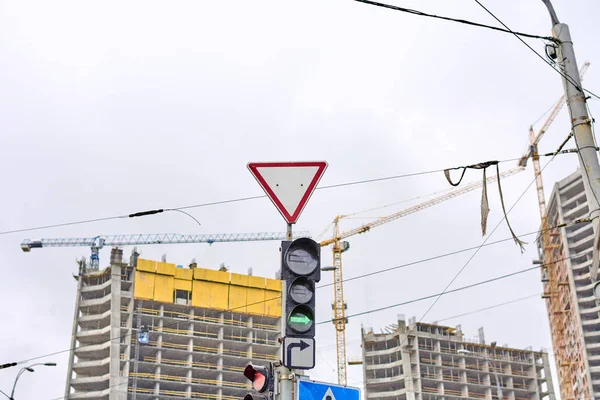 Sign give way against the sky and building