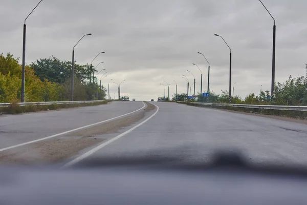 smooth asphalt road with divided road signs