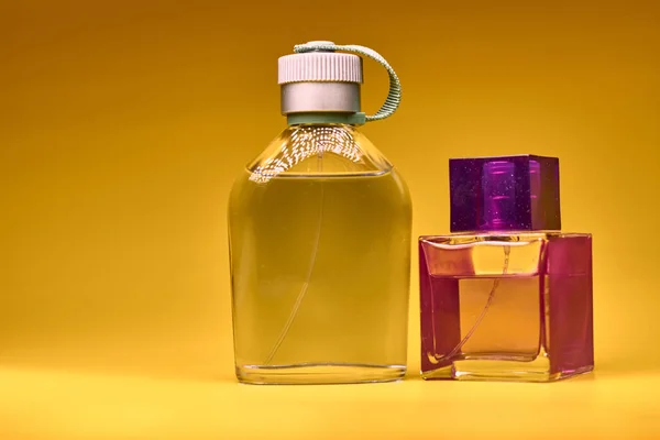 Perfume bottles on yellow background. Minimal style