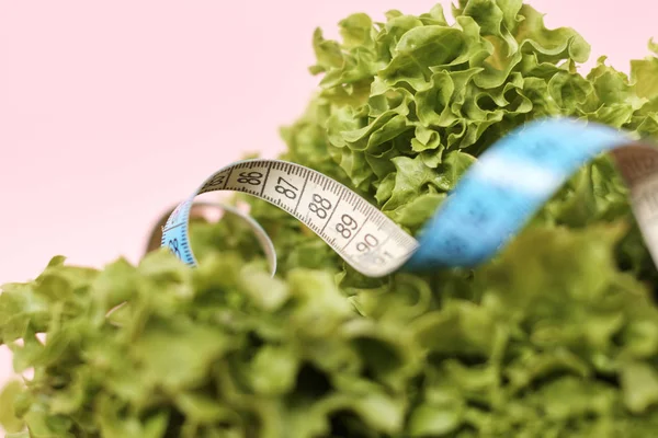 green salad leaves with measurement tape