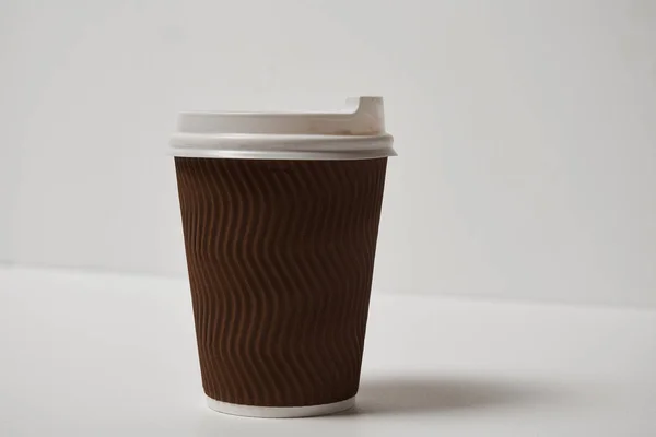 close-up view of disposable coffee cup on white background