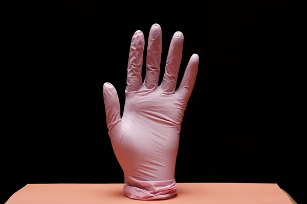 close-up view of medical glove on black background