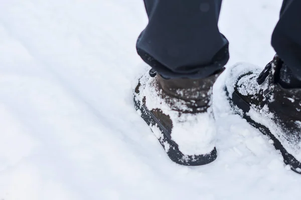 Woman feet in snow boots, closeup.