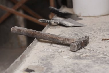 Çekicin yakın görüntüsü ve gri beton yüzeydeki araçlar