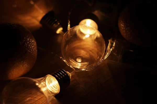 Garland of vintage lamp bulbs on dark background