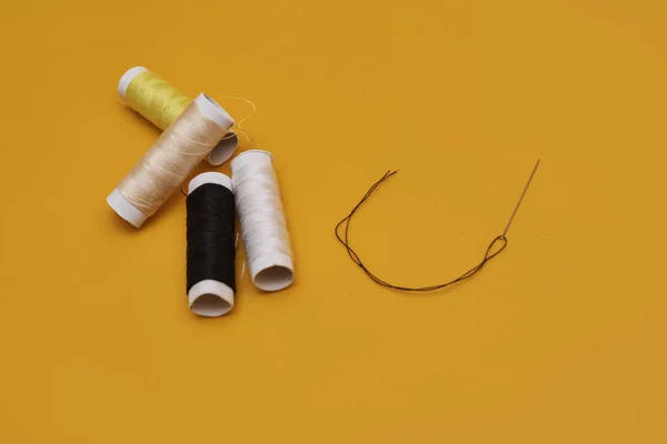 close-up view of threads on yellow background