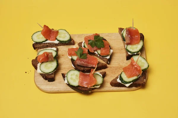 Sandwiches Con Salmón Pepinos Servidos Sobre Tabla Madera Sobre Fondo — Foto de Stock