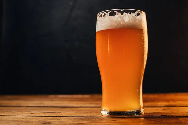 beer mug, glass of cold light beer on wooden table