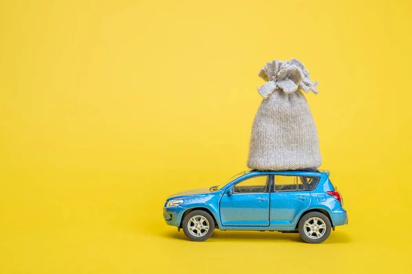 toy car and a gift on yellow background