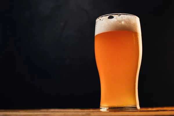 Nahaufnahme Von Kaltem Bier Glas Auf Holztisch Auf Schwarzem Hintergrund — Stockfoto