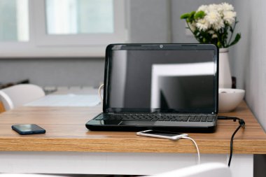 bilgisayar ve akıllı telefonlar ahşap masada.