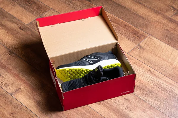 Close Άποψη Των Κομψών Μαύρα Sneakers Κουτί Στο Ξύλινο Πάτωμα — Φωτογραφία Αρχείου