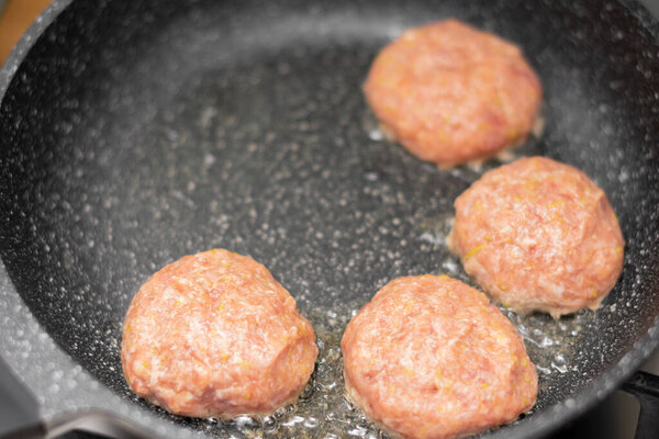frying pan with fried meat cutlets on the grill