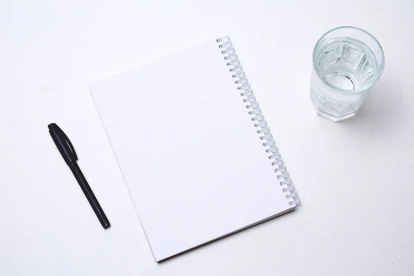 Notebook Pen Glass Water White Background — Stock Photo, Image