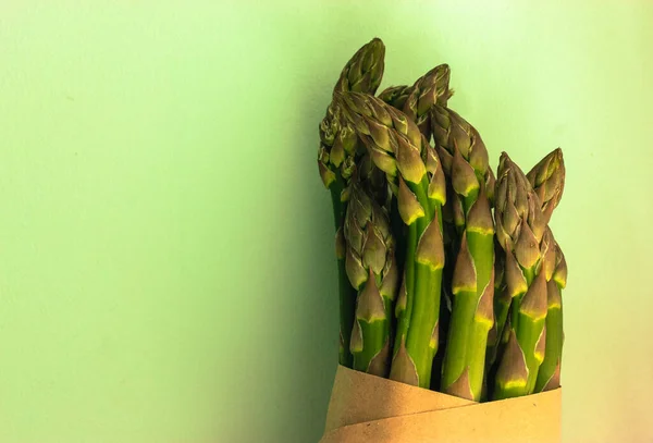 Asparagus. Fresh green asparagus on a light green clear background.