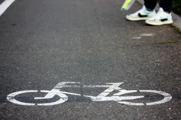Bicycle sign on the asphalt: a bike path for safe riding in the city