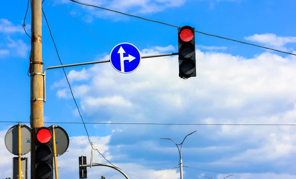 Red traffic light signal against a blue sky: a pointer for the motorist on the road