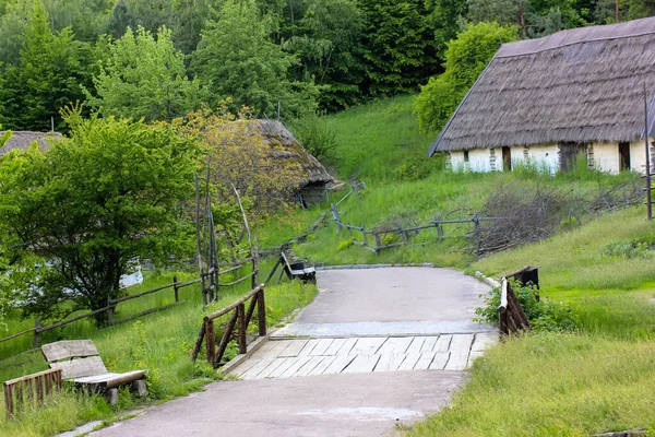 Ukrán hagyományos falu: fehér agyagházak nádtetővel és gyönyörű természettel. — Stock Fotó