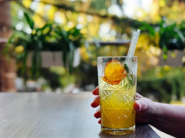 Portakal dilimli yaz içeceği ve kristal bardakta nane şekeri. Doğal Bokeh, ekolojik estetik ve sıcak günler için sağlıklı içecek ilhamı ile moda açık hava yaşam tarzı konsepti.