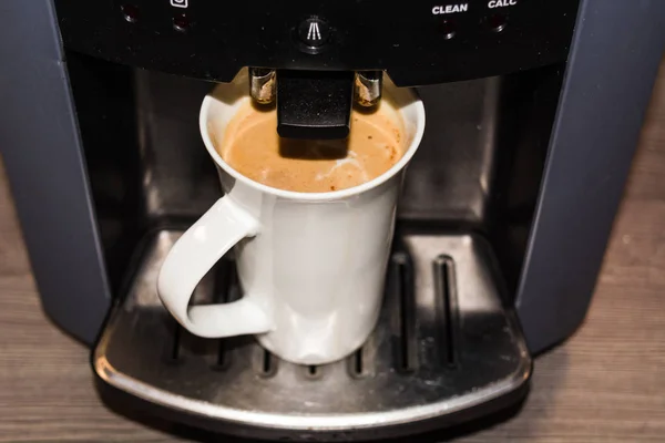 Office coffee machine, professional machine with a cup full of coffee according to slat type.