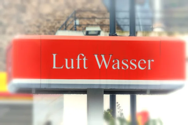 Red billboard with inscription in German \