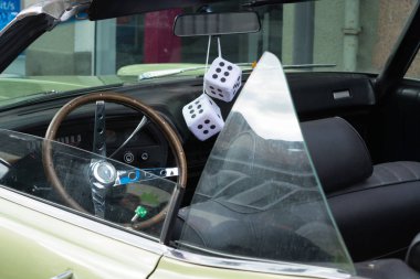 Fuzzy Dice on the rearview mirror         clipart