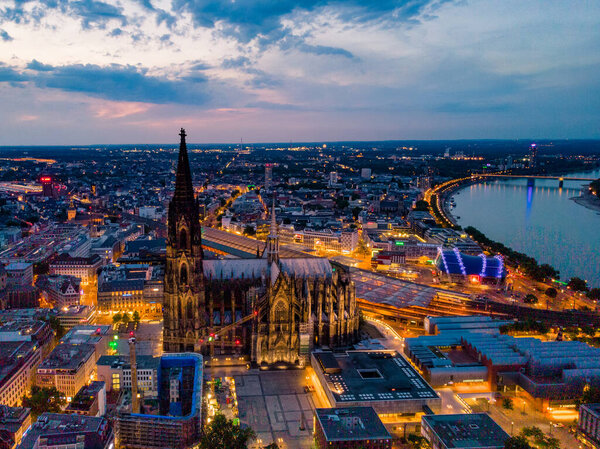 Colgne Koln Cathedral during sunset , drone aerial vie over Cologne and the river rhein during sunset in Germany Europe dusk