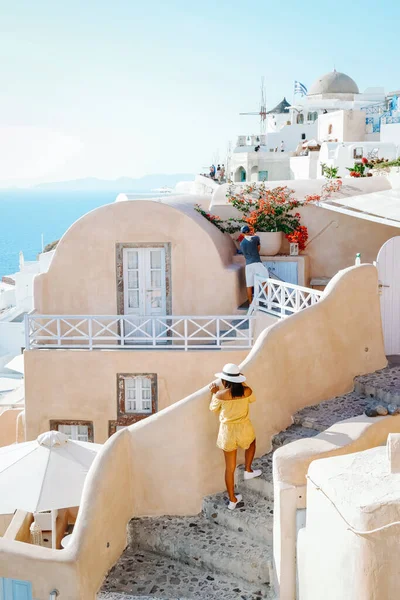 Santorini Greece, woman on luxury vacation Oia Santorini Island greece visit the white village with beautiful building overlooking the caldera