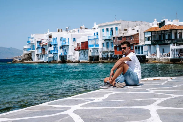Young guy on vacation at the Greek Island of Mykonos, men relaxing at the little venice village of Mykonos Island — Stock Photo, Image