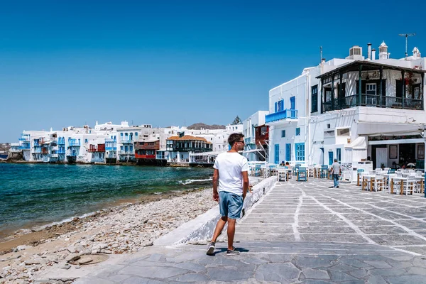 Young guy on vacation at the Greek Island of Mykonos, men relaxing at the little venice village of Mykonos Island — Stock Photo, Image