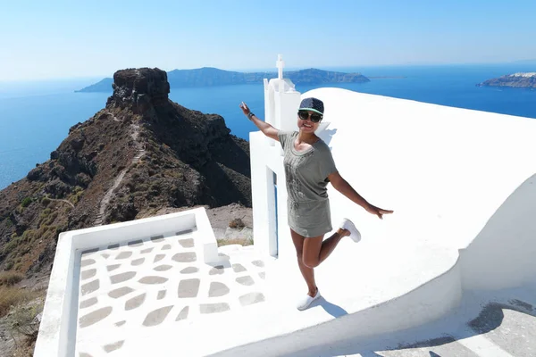 Santorini Greece, woman on luxury vacation Oia Santorini Island greece visit the white village with beautiful building overlooking the caldera