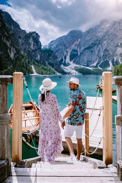 couple visit the famous lake Lago Di Braies Italy, Pragser Wildsee in South Tyrol, Beautiful lake in the italian alps, Lago di Braies