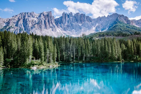 bleu lake in the dolomites Italy, Carezza lake Lago di Carezza, Karersee with Mount Latemar, Bolzano province, South tyrol, Italy. Landscape of Lake Carezza or Karersee and Dolomites in background