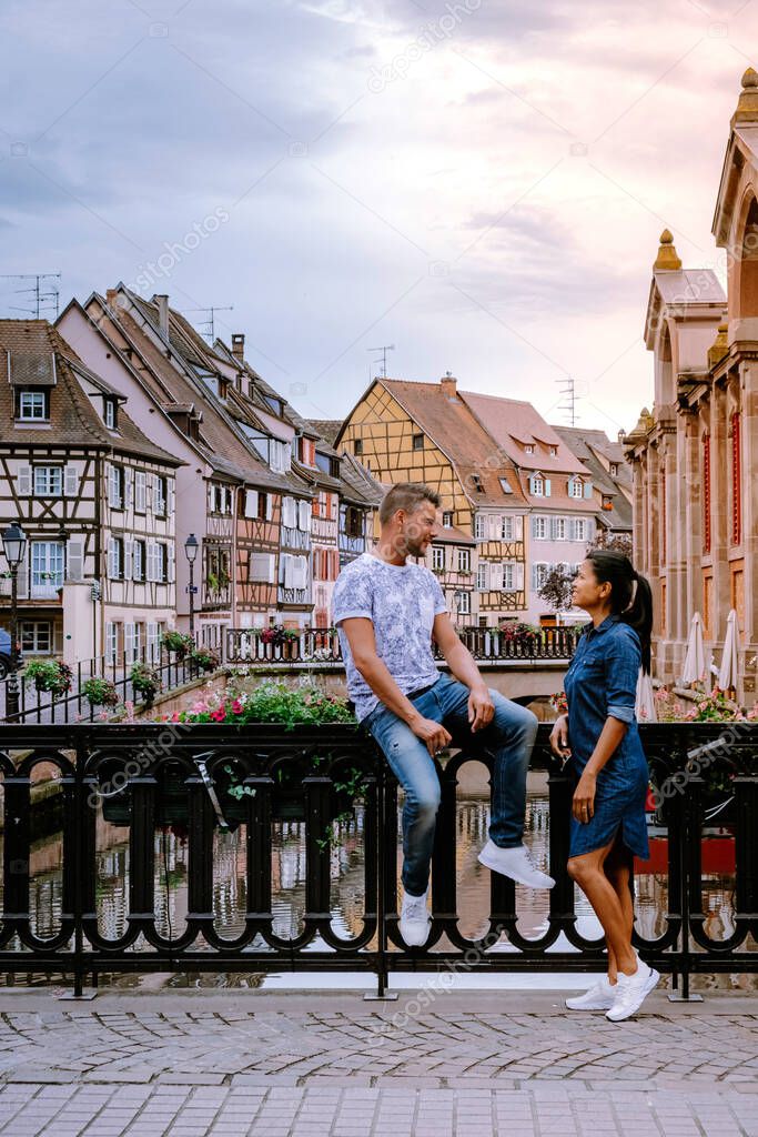 couple on city trip Colmar, Alsace, France. Petite Venice, water canal and traditional half timbered houses. Colmar is a charming town in Alsace, France. Beautiful view of colorful romantic city