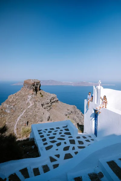 Pareja de hombres y mujeres de vacaciones Santorini, Vista al mar y al volcán desde Fira la capital de la isla de Santorini en Grecia — Foto de Stock