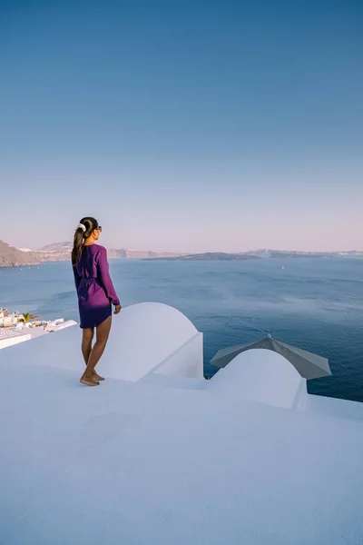 Pôr do sol na ilha de Santorini Grécia, bela aldeia caiada de branco Oia com igreja e moinho de vento durante o pôr do sol Mulher em férias de luxo Grécia — Fotografia de Stock