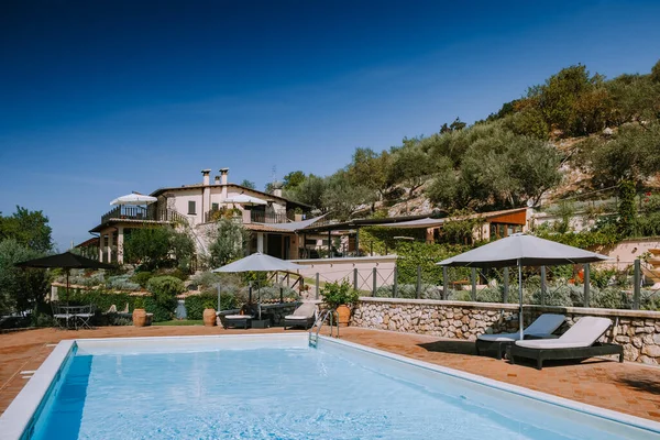 Luxury country house with swimming pool in Italy, Couple on Vacation at luxury villa in Italy, men and woman watching sunset