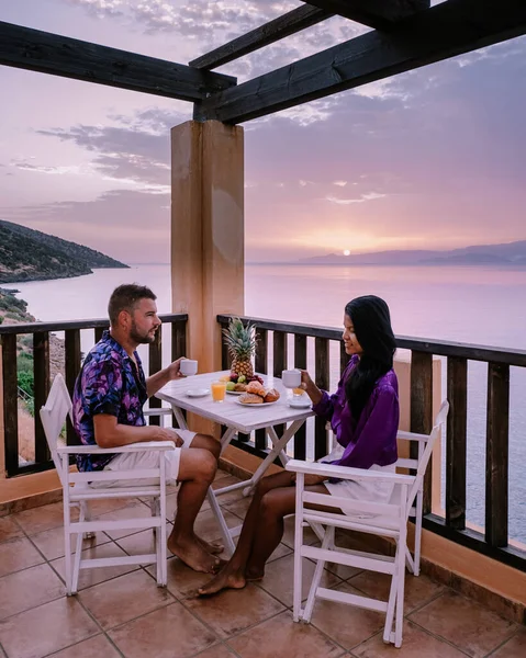 Mesa y sillas con desayuno durante el amanecer en el mar meditario en Grecia —  Fotos de Stock