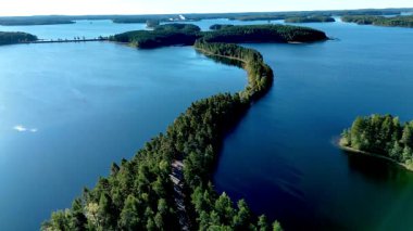 Finlandiya 'da bereketli yeşil ormanların berrak gökyüzünün altında sakin mavi göllerle buluştuğu büyüleyici Punkaharju eskerini keşfedin. Doğayı sevenler için mükemmel bir yer, Punkaharju Doğa Koruma Alanı göl yolu
