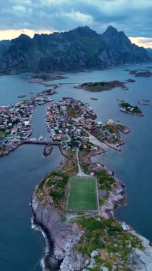 Norveç, Lofoten 'de büyüleyici bir balıkçı kasabası olan Henningsvaer' in nefes kesici cazibesini keşfedin. İnsansız hava aracı bir futbol sahası