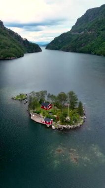 Serene suları Norveç 'teki küçük bir adada flordları sersemleten güzel kırmızı bir kulübeyi kucaklıyor. Çevredeki yemyeşil manzaralar huzurlu bir geri çekilme yaratıyor. Doğa aşıkları için ideal..