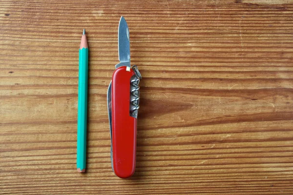 Multi Tool Swiss Army Red Knife Geen Pencil Isolated Wooden — Stock Photo, Image