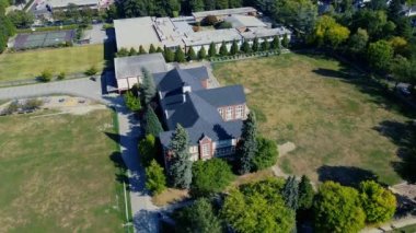 Okul manzarası, spor salonu ve boş çocuk parkları.