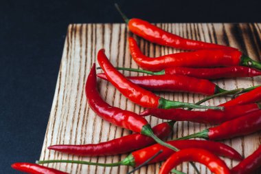 Kesme tahtasında acı kırmızı biber. Siyah arkaplan