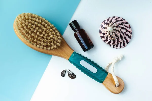 Anti-cellulite massage brush for the body and aroma oil. Spa treatments. Ecological cosmetics for the body