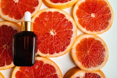 Greyfurt özlü bir şişe. Moda tarzında organik doğal kozmetik ürünü. Deri gerdirme için anti-yaş kozmetikleri. Serum siyah cam şişede. Metin için yer