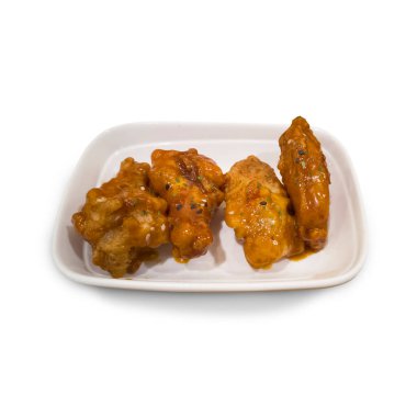 Beyaz arka planda soslu Smokey BBBQ tavuk kanatları.