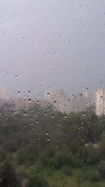 Pencere camındaki yağmur damlaları durgunluk, melankolik ve sükunet yaratır. Yağmurlu havayı ve yalnızlığı ifade eder. Yumuşak bulanıklık ve dikey arkaplanda yansıma yaratır.
