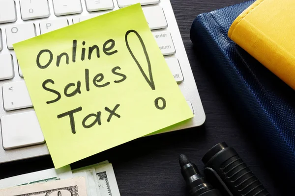 Online sales tax on a keyboard and money.