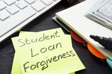 Student loan forgiveness written on a memo stick. clipart